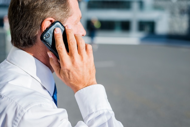 Close-up of a businessman talking on cellphone