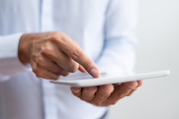 Close-up of businessman in white shirt pointing with finger