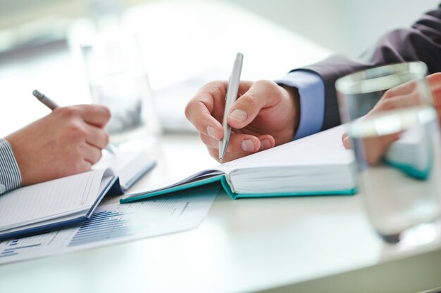 Close-up of businessmen writing ideas