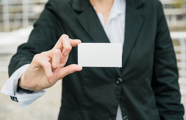 Free Photo close-up of a businesswoman showing white blank business card