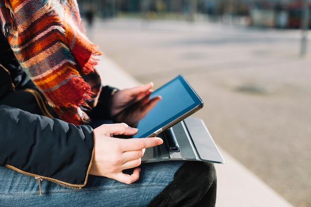 Close up of businesswoman working outdoors with tablet