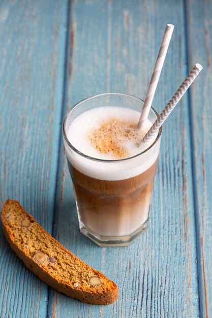 Close-up cappuccino with milk and biscuit