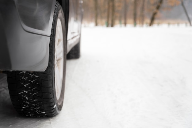 Free photo close up on car tire during winter roadtrip