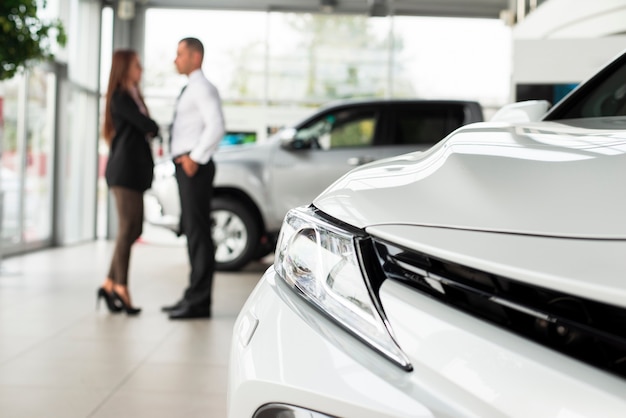 Close-up car with man and woman behind