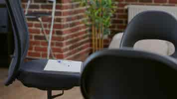 Free photo close up of chairs in circle used for aa group meeting with people and therapist. office with furniture designed for therapy session against alcoholism and drug addiction. rehab space