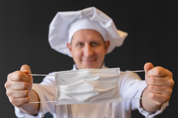 Free photo close-up chef holding medical mask