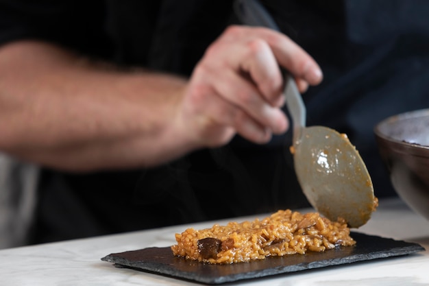 Close up chef preparing food plate