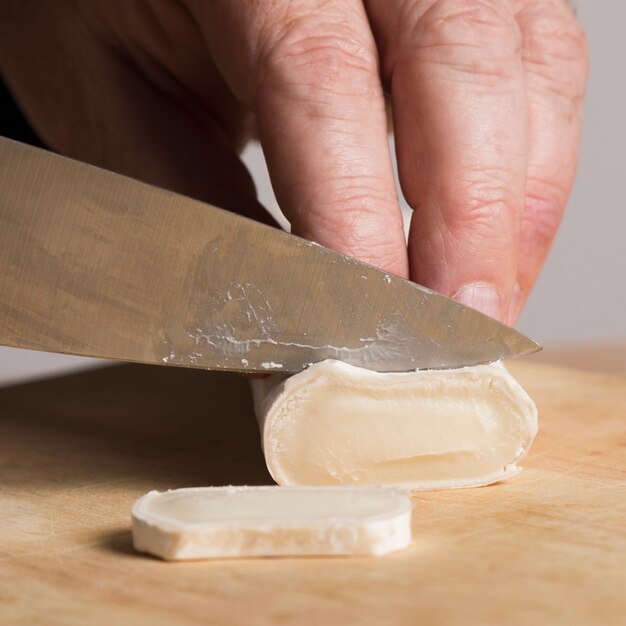 Close-up chef slicing vegetable