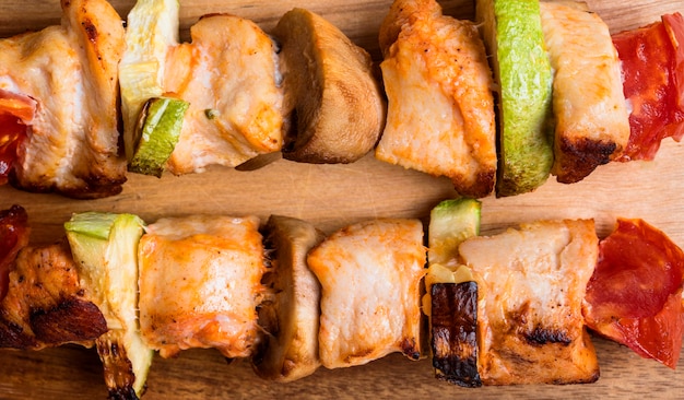 Close-up chicken skewers on cutting board