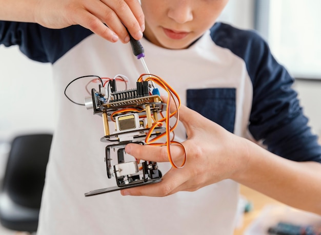 Close up child making robots