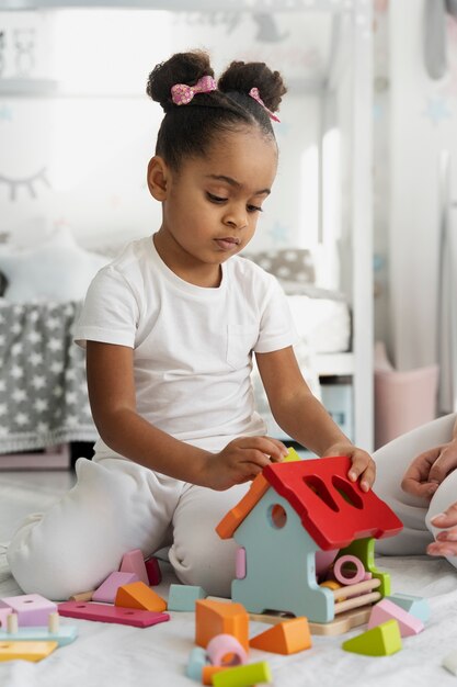 Close up on child playing with didactic game