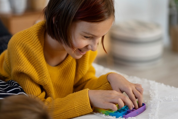 Free Photo close up on child playing with pop it toy