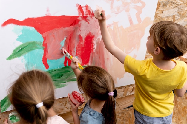 Close up children painting together