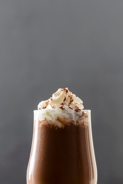 Free photo close-up of chocolate milkshake with cream