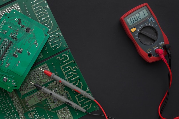 Free photo close-up circuit board with multimeter