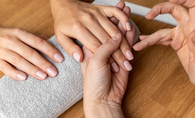 Close up client getting manicure