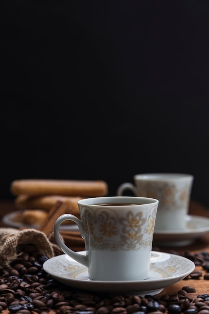 Close-up coffee beans near cup