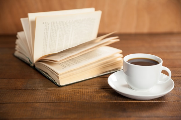 Close-up of coffee cup and book