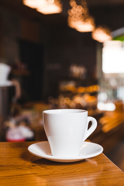 Close-up of coffee cup on wooden table in coffee shop