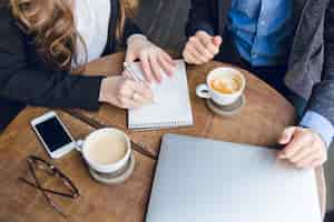 Free photo close-up of a coffee table with two colleague