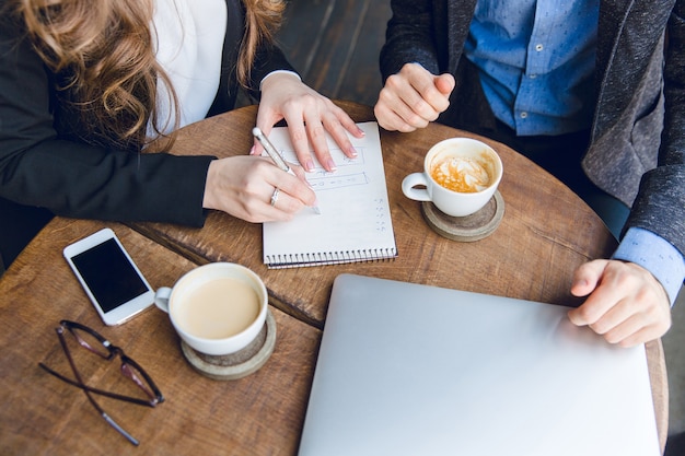 Close-up of a coffee table with two colleague