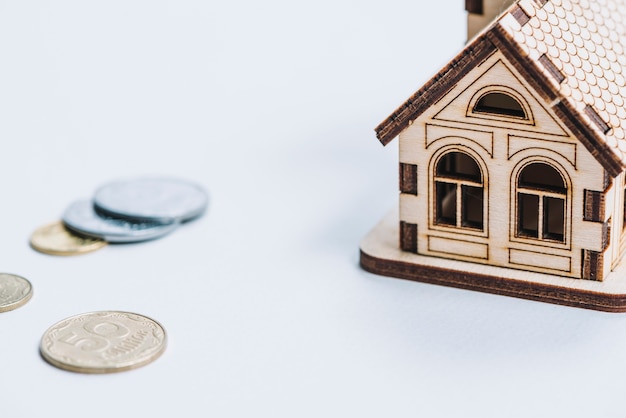 Free photo close-up coins near small house