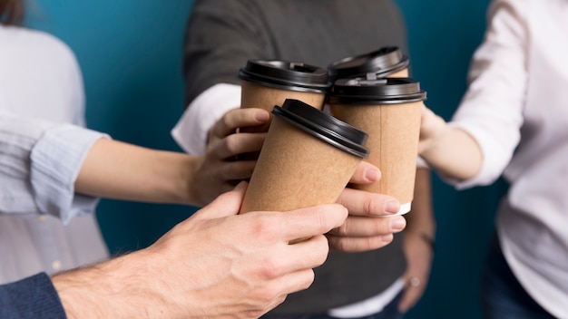 Close-up colleagues having coffee together