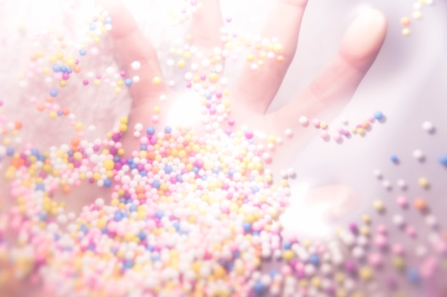 Close-up of colorful sprinkles under hand