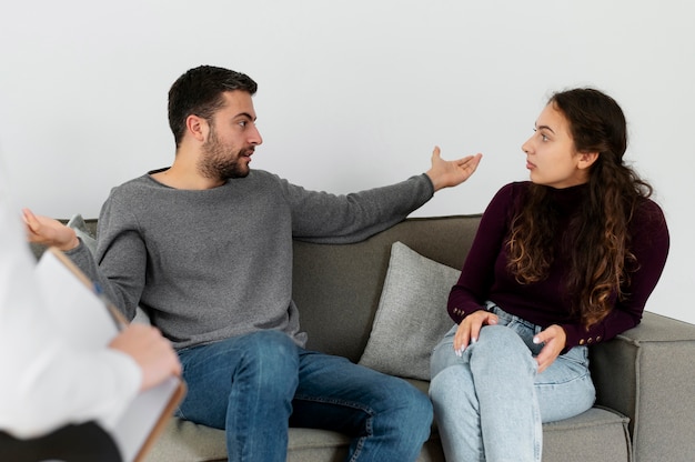 Close up couple arguing in therapy