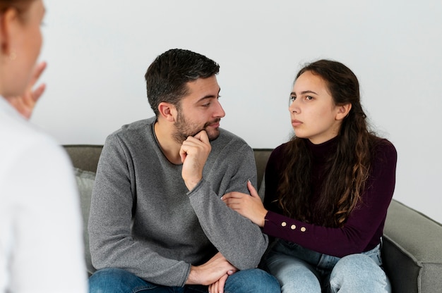 Close up couple discussing with therapist