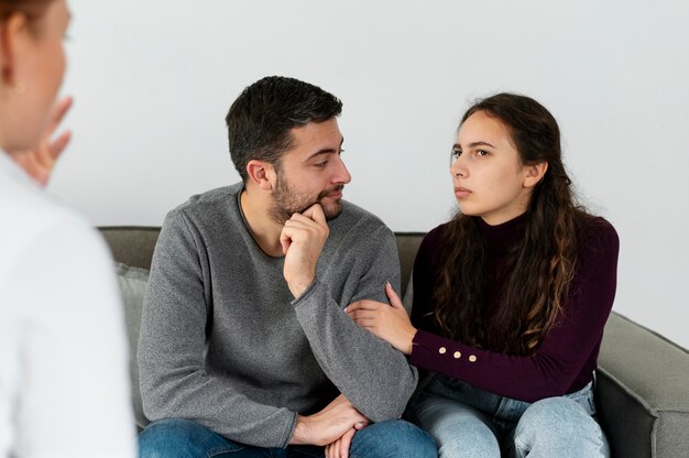 Close up couple discussing with therapist