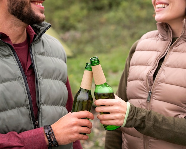 Free photo close-up couple having a drink in nature