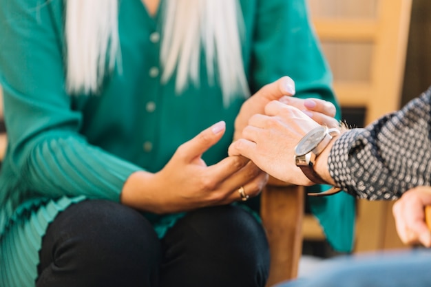 Free Photo close-up of couple holding each other's hand