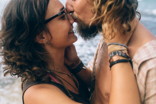 Close-up couple kissing at sea