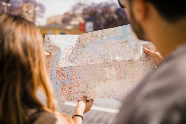 Close-up of couple looking at map