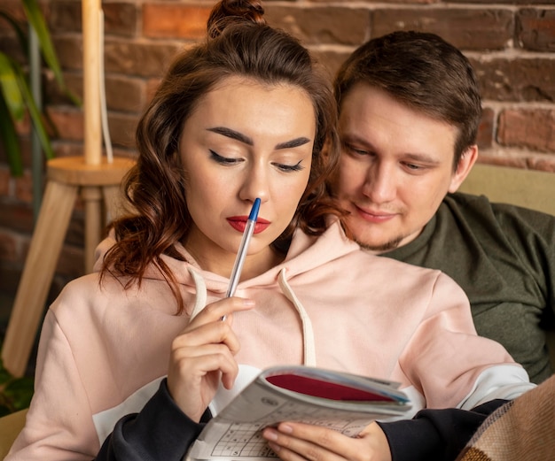 Free photo close up couple making crossword puzzle