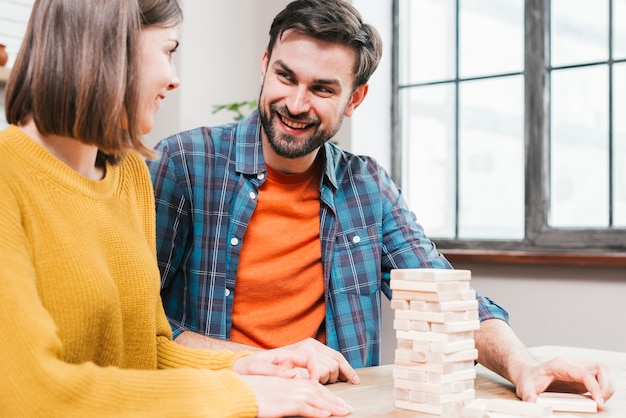 Free Photo close-up of couple playing block stacking game at home