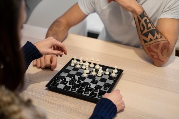 Free Photo close up couple playing chess at home