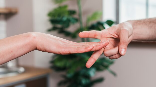 Close-up of couple playing the rock paper scissors game