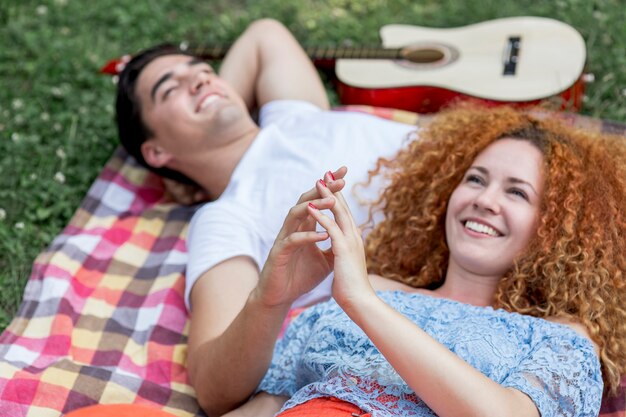 Close up of a couple touching hands and smiling