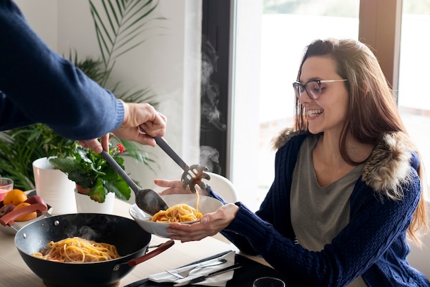 Close up couple with food at home