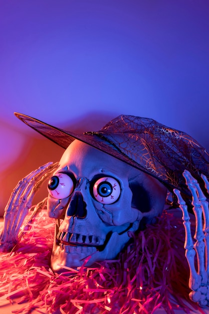 Free photo close-up creepy halloween skeleton with confetti