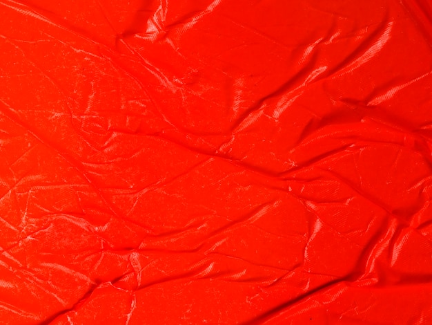 Free photo close-up crumpled red paper background