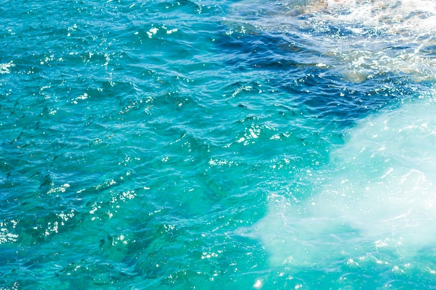 Close-up crystalline wavy water at the beach