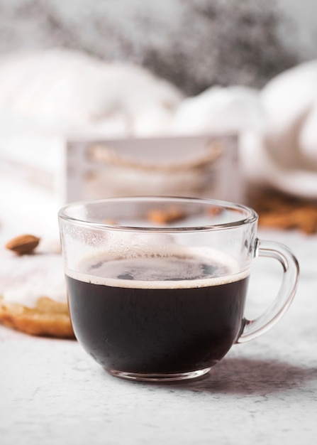 Close-up cup of coffee with donut