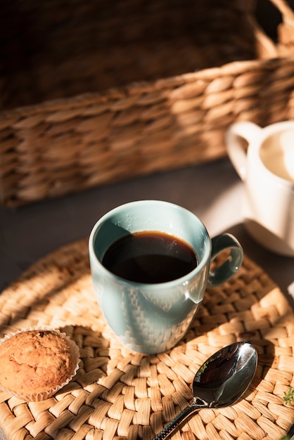 Close-up cup of coffee with a muffin