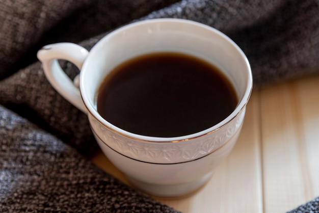 Close-up cup of coffee with wooden table