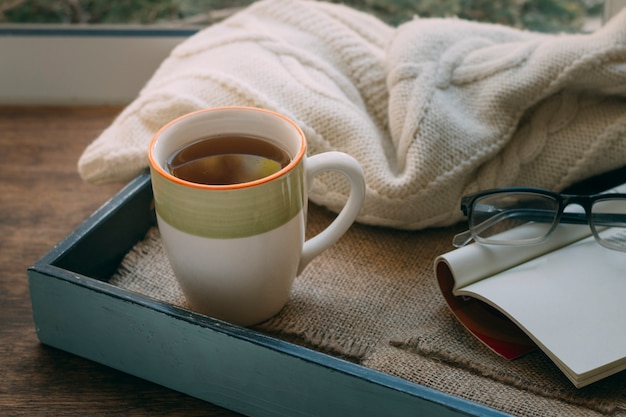 Free photo close-up cup of tea with a blanket