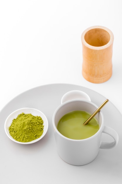 Free photo close-up cup with matcha tea and powder