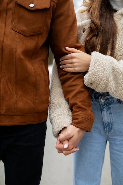 Close up cute couple holding hands